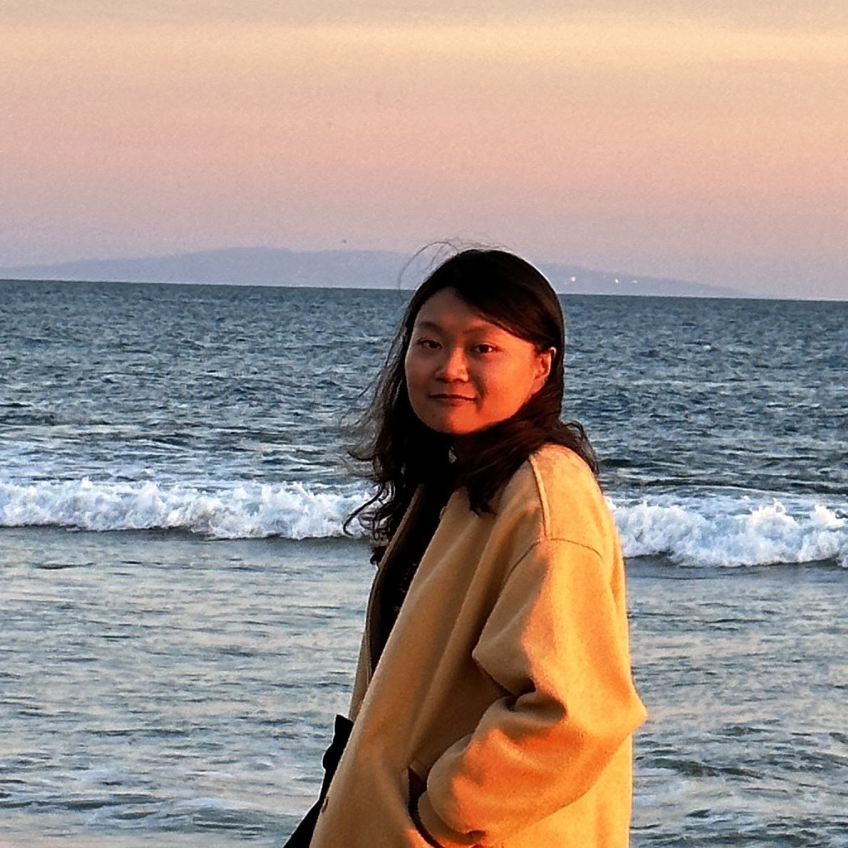 A girl enjoying a beautiful day and smiling at Malibu Beach.